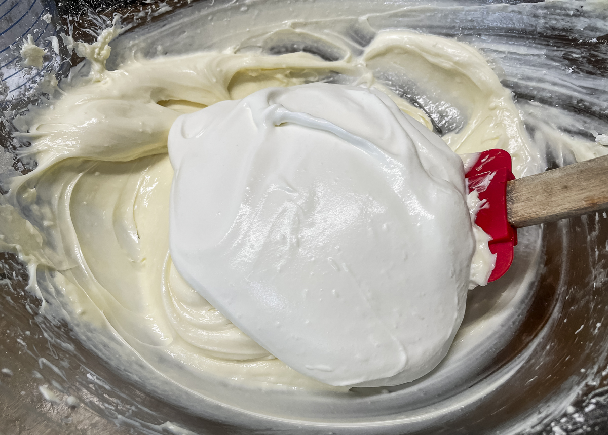 Gently fold the whipped cream into the sweetened cream cheese a bit at a time.